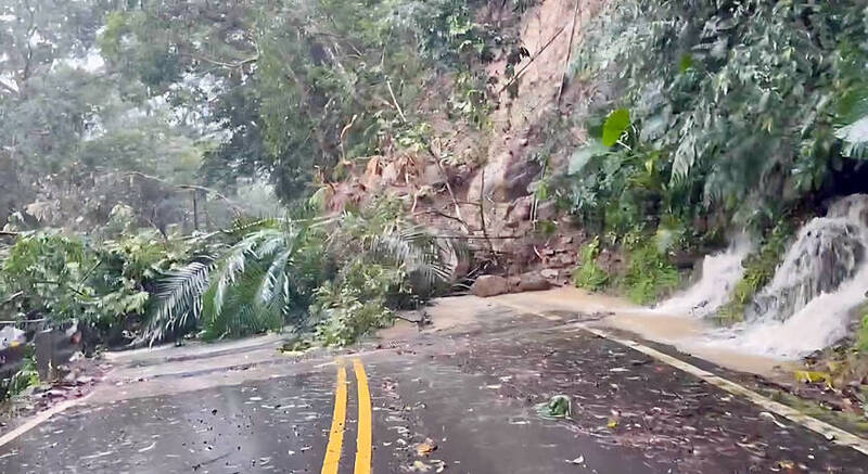 A road in Miaoli County’s Nanjhuang area is seen obstructed following a landslide as Typhoon Bavi batters Taiwan yesterday.
Photo courtesy of a member of the public