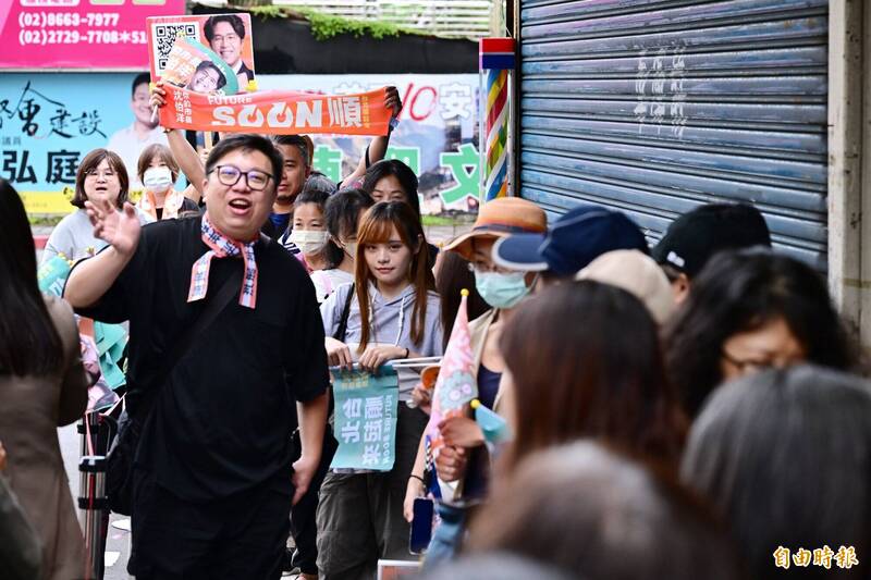 台北市長參選人沈伯洋走訪木柵市場掃街拜票，「洋流」支持者提前到場排隊。（記者陳逸寬攝）