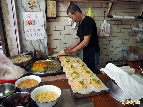 因為來客量大，店家都是將潤餅皮鋪在長台上，一次包12捲。（記者陳昀攝）