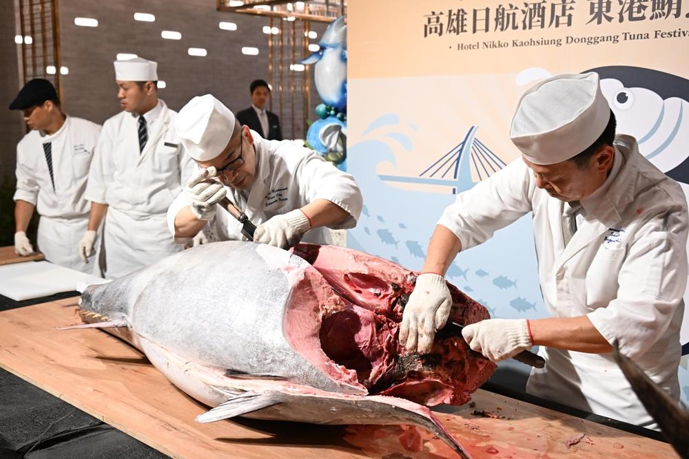 兩位料理長細心的黑鮪魚背部與頭部細心劃開。（記者李惠洲攝）