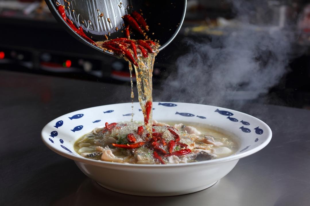 每份酸菜魚獨立烹調，沖入辣椒、白芝麻、蒜末特製的熱油爆發誘人香氣。（圖／業者提供）