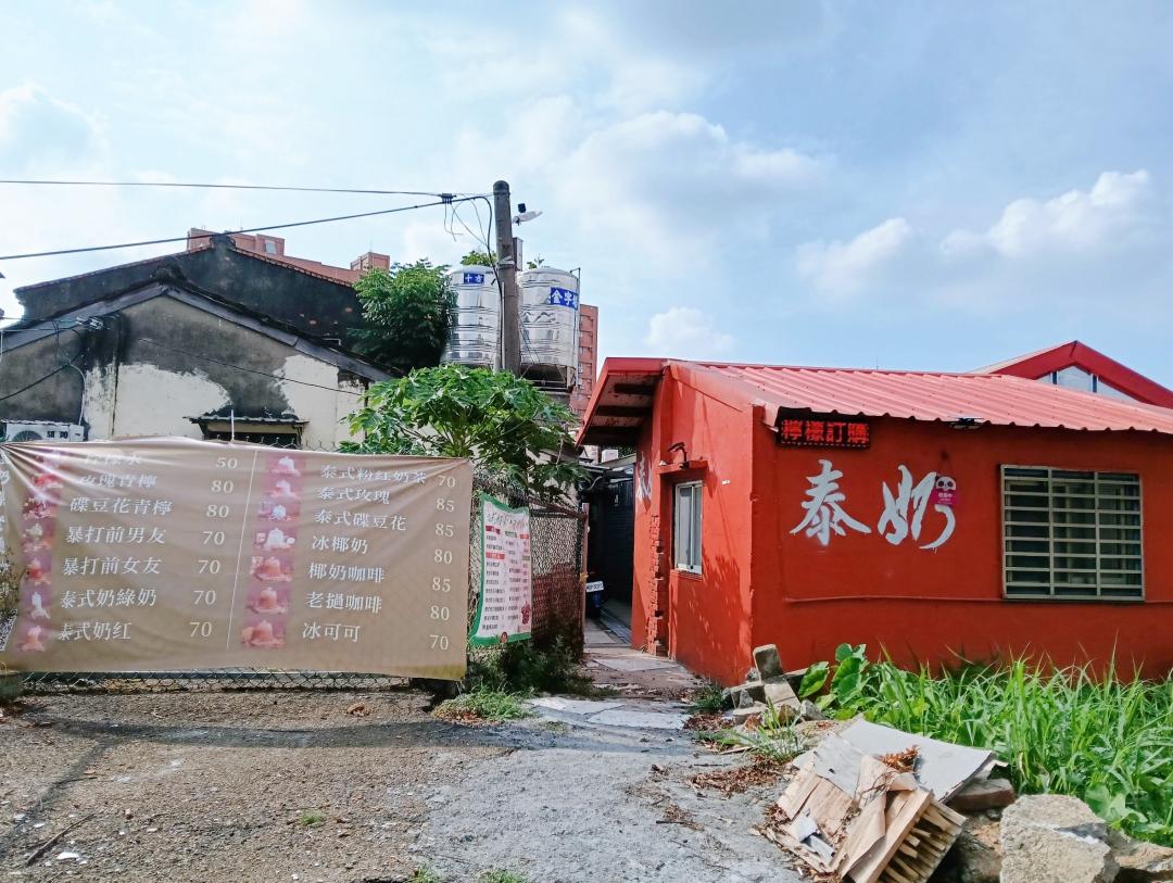 桃園中壢近期爆紅的「泰式奶茶老撾咖啡」，外觀是橘紅色老厝寫著大大的泰奶。（圖／民宿女王芽月提供）