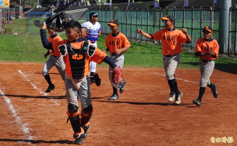 南投縣以8：7險勝花蓮紅，全隊興奮地衝進場內慶祝。（記者徐正揚攝）