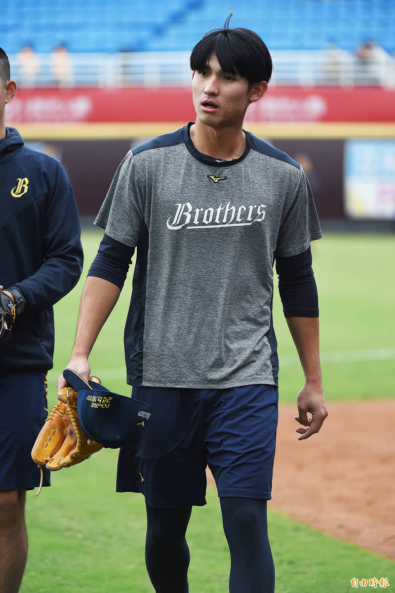 中信兄弟陳文杰在守備練習時不慎和幫忙撿球的球僮相撞，造成左膝不適。（記者陳志曲攝）