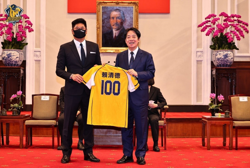 副總統賴清德（右）收下中信兄弟老闆辜仲諒送的背號100球衣。（中信球團提供）