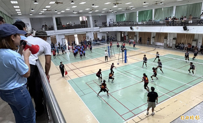 華宗盃排球錦標賽國小女童比賽，隊職員和家長場邊拿加油棒、喇叭助陣加油。（記者楊金城攝）