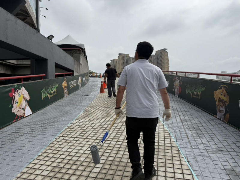 邱俊憲拿起刷子，幫澄清湖棒球場地板塗止滑漆。（圖擷自邱俊憲臉書）