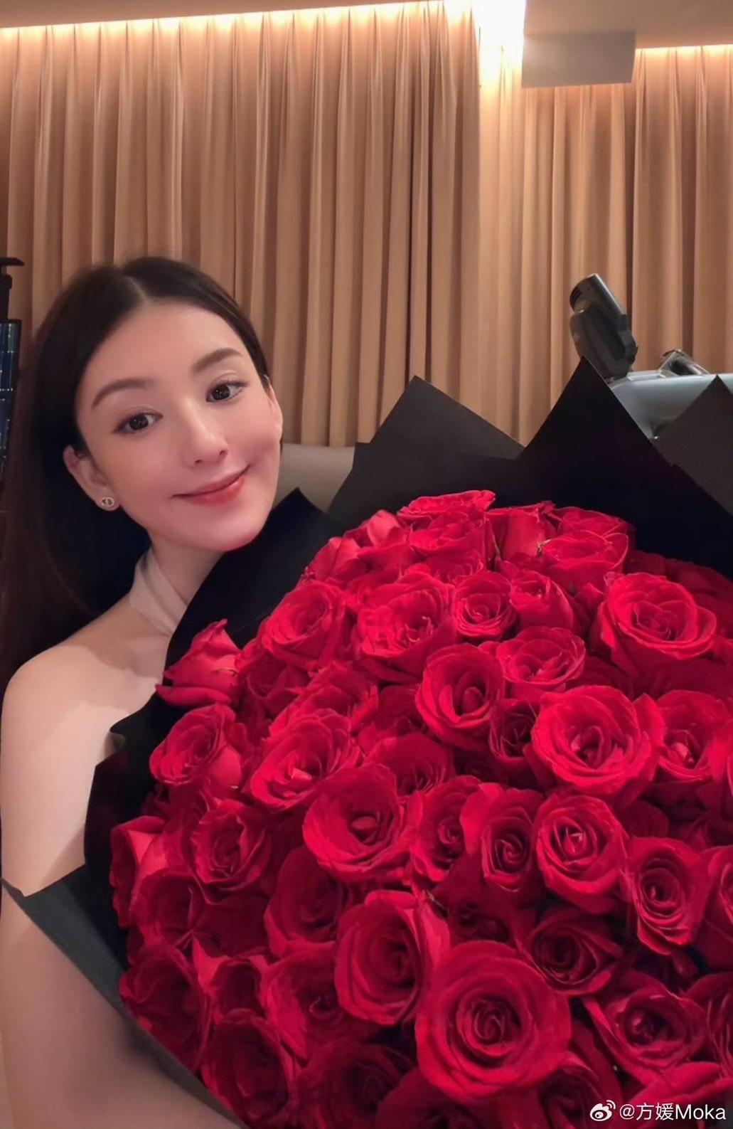 手捧大束玫瑰的方媛，一臉幸福。
