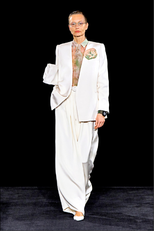 男裝剪裁語彙融入女裝設計，俐落外套搭配柔軟透膚的上衣與領帶，描繪剛柔並濟的當代風貌。