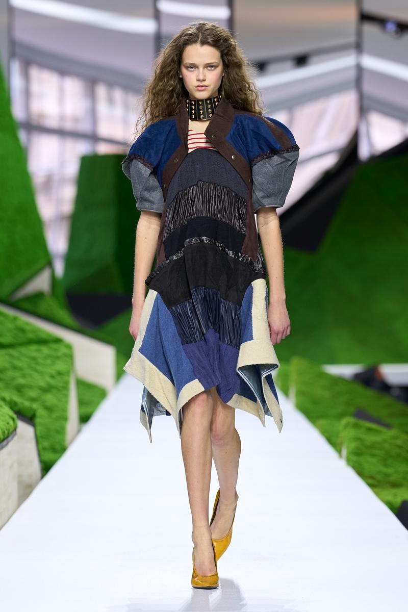 以自然景觀為靈感，拼接面料與不對稱剪裁交織層次，搭配金屬鉚釘頸飾展現品牌結合工藝與未來感的設計語言。（Louis Vuitton提供）