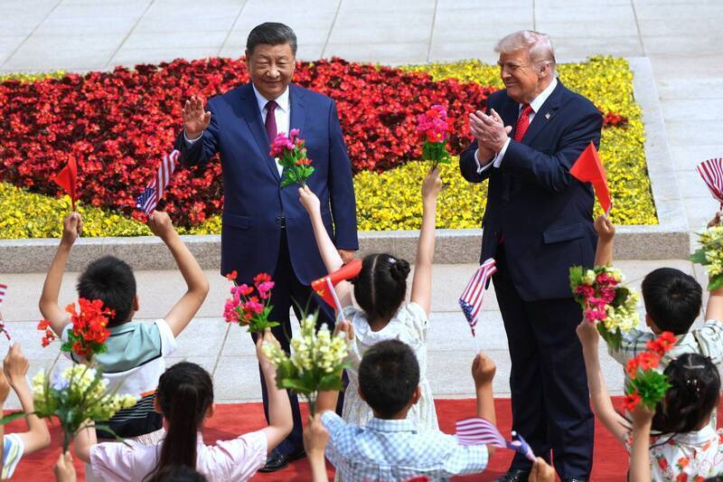 川普（右）由习近平（左）陪同在北京人民大会堂前接受中方军礼欢迎，现场安排儿童列队手持美中国旗与花束跳着雀跃的步伐高声欢呼热烈欢迎。 （美联社文件照）